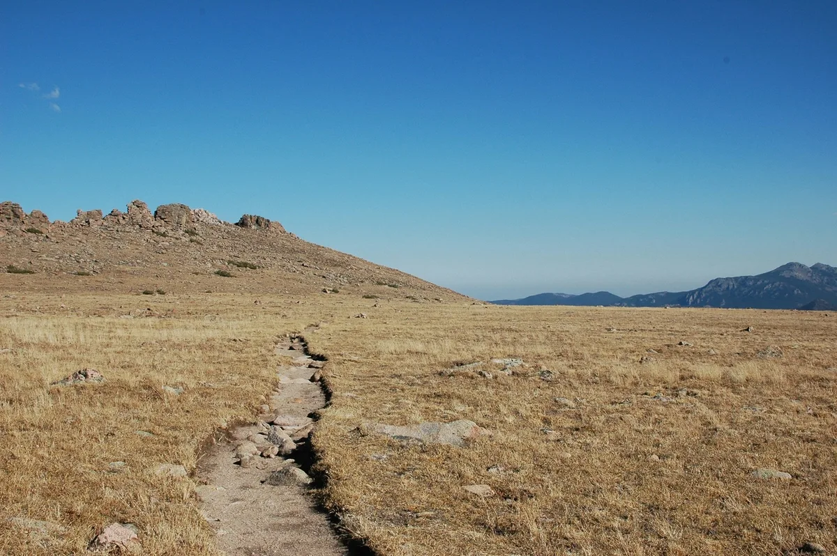 An alpine trail crossing a rocky mountainside