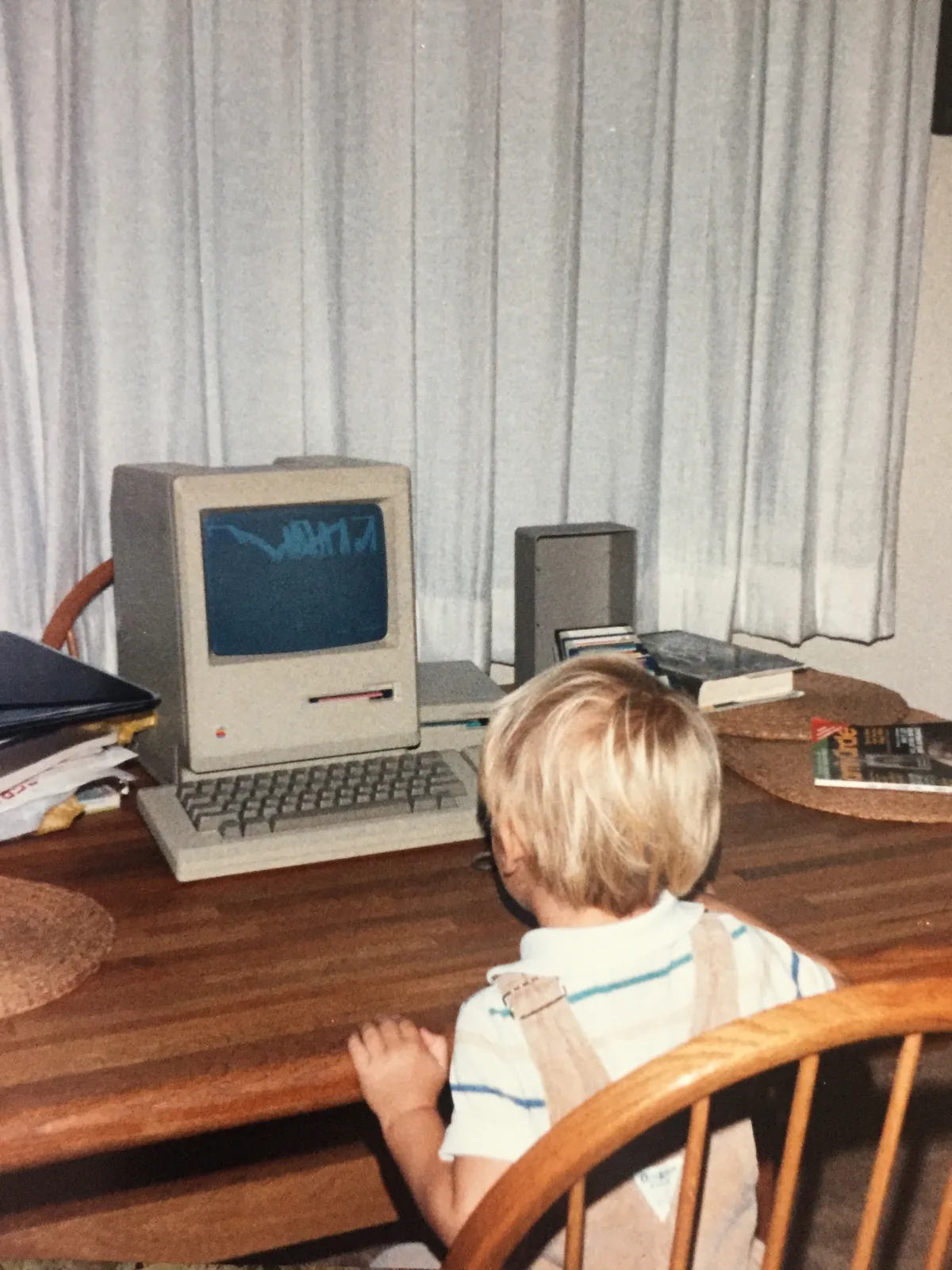 Aaron Hutten as a child seated at his first computer