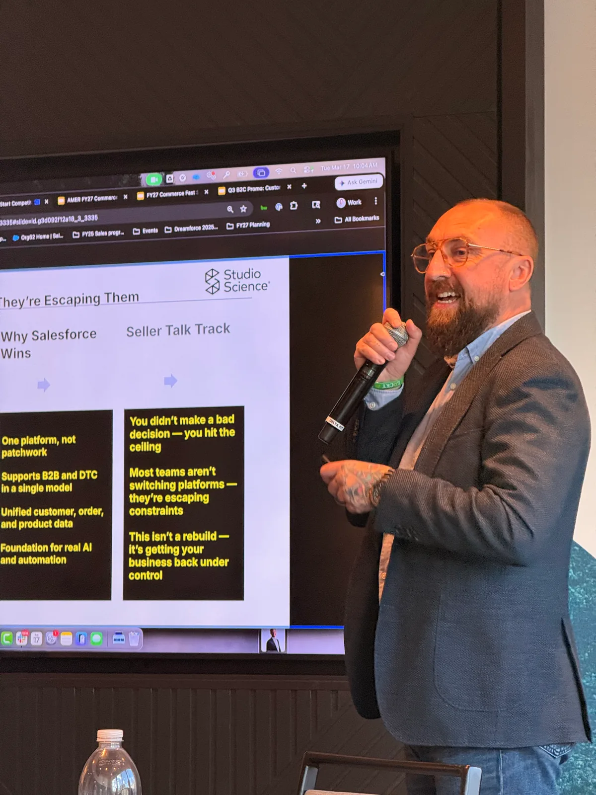 Aaron Hutten speaking into a microphone during a technology presentation